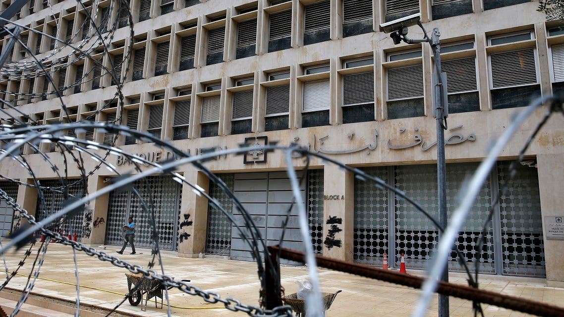 A worker walks outside the Lebanese Central Bank that has been shut down as part of the preventive measures against the coronavirus, in Beirut, Lebanon. (File photo: AP)
