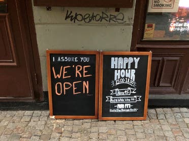 A sign assures people that the bar is open during the coronavirus outbreak, outside a pub in Stockholm, Sweden March 26, 2020. (Reuters)