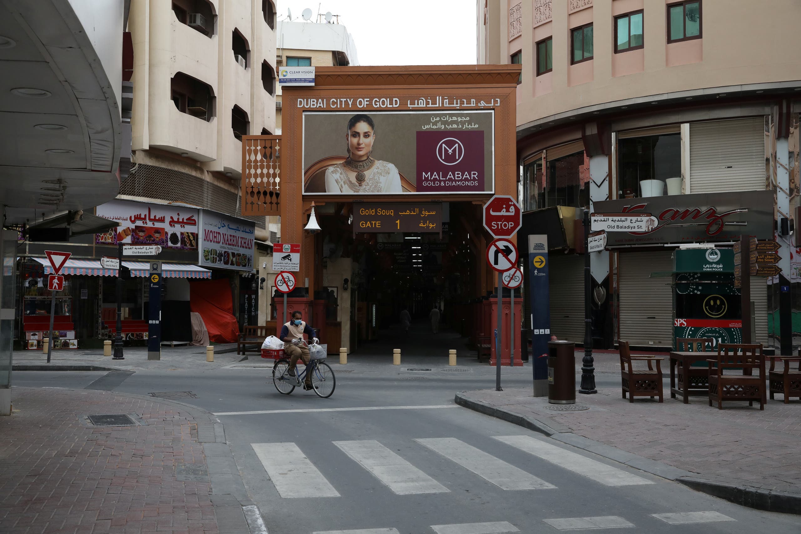 A man rides a bicycle past the deserted Gold Souq, a popular tourist destination, before the full lockdown, following the outbreak of the coronavirus in Dubai on March 28, 2020. (Reuters) 