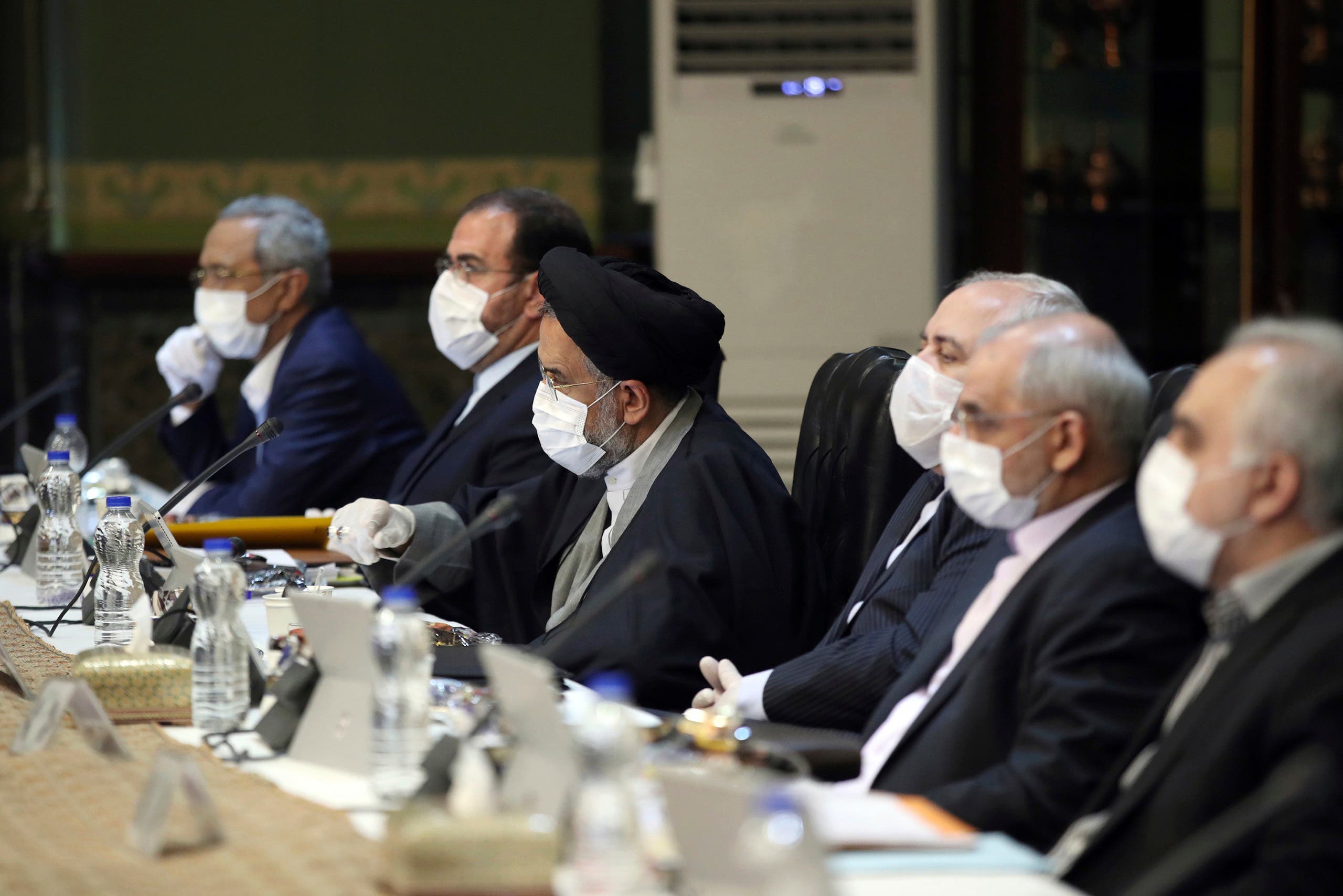 Iranian cabinet members wearing face masks and gloves attend their meeting in Tehran on March 18, 2020. (AP)