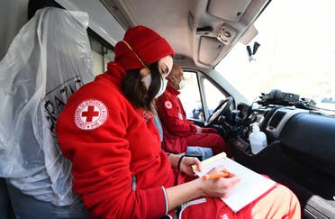 Members of the Red Cross sit inside a vehicle outside the Molinette Hospital on Palm Sunday, during the coronavirus outbreak, in Turin, Italy April 5, 2020. (Reuters)