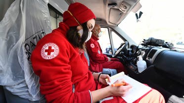 Members of the Red Cross sit inside a vehicle outside the Molinette Hospital on Palm Sunday, during the coronavirus disease (COVID-19) outbreak, in Turin, Italy April 5, 2020. REUTERS/Massimo Pinca