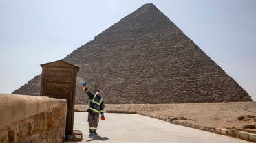 Municipal workers sanitize the areas surrounding the Giza pyramids complex in hopes of curbing the coronavirus outbreak in Egypt, Wednesday, March 25, 2020. (AP)