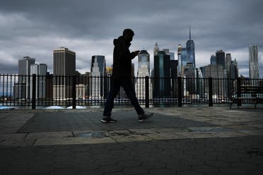 The Manhattan skyline stands in the distance as people try to get some time outside in Brooklyn on April 04, 2020 in New York City. (AFP)