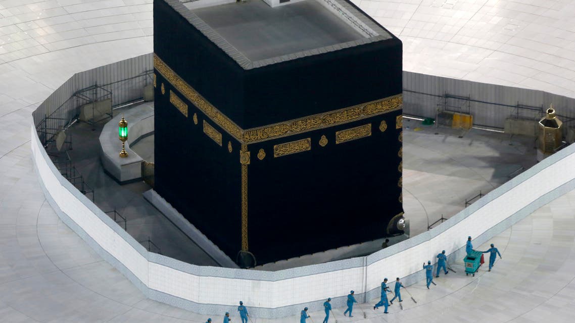 Workers disinfect the ground around the Kaaba, the cubic building at the Grand Mosque, in the Muslim holy city of Mecca, Saudi Arabia, Saturday, March 7, 2020. (AP)