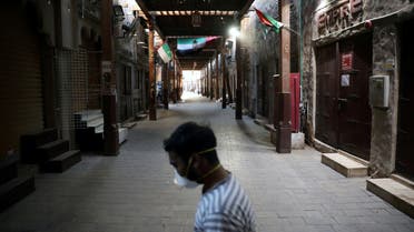 A man wearing a protective face mask walks through the deserted Barajeel Souq, following the outbreak of the coronavirus disease (COVID-19), in old Dubai, United Arab Emirates, March 31, 2020. (Reuters)
