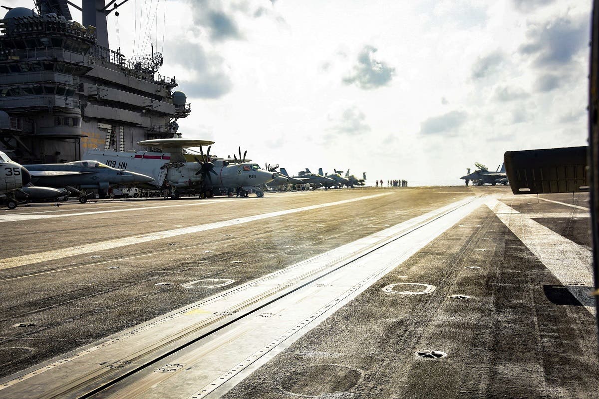 Planes are parked on the flight deck of the US Navy aircraft carrier USS Theodore Roosevelt in the Philippine Sea March 18, 2020. (Reuters)