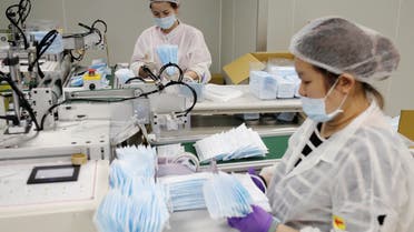 A worker packs surgical masks on the production line in a factory in Taoyuan, Taiwan April 6, 2020. REUTERS/Ann Wang