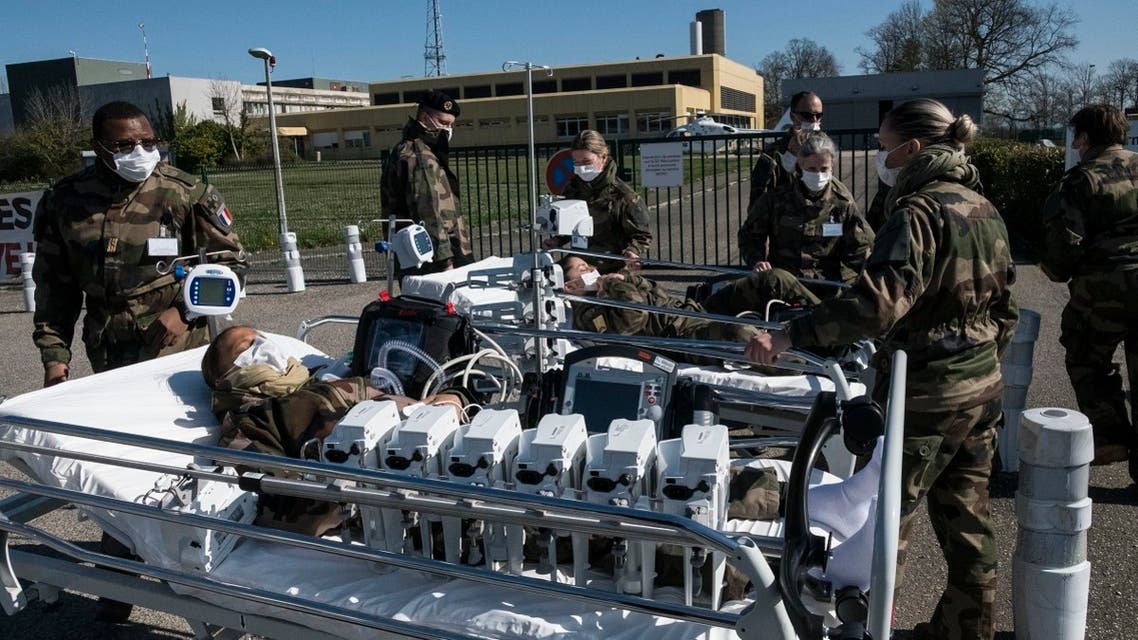 French soldiers transport soldiers on gurneys during a drill on March 24, 2020 at the military field hospital set up outside the Emile Muller Hospital in Mulhouse, eastern France. (AFP)