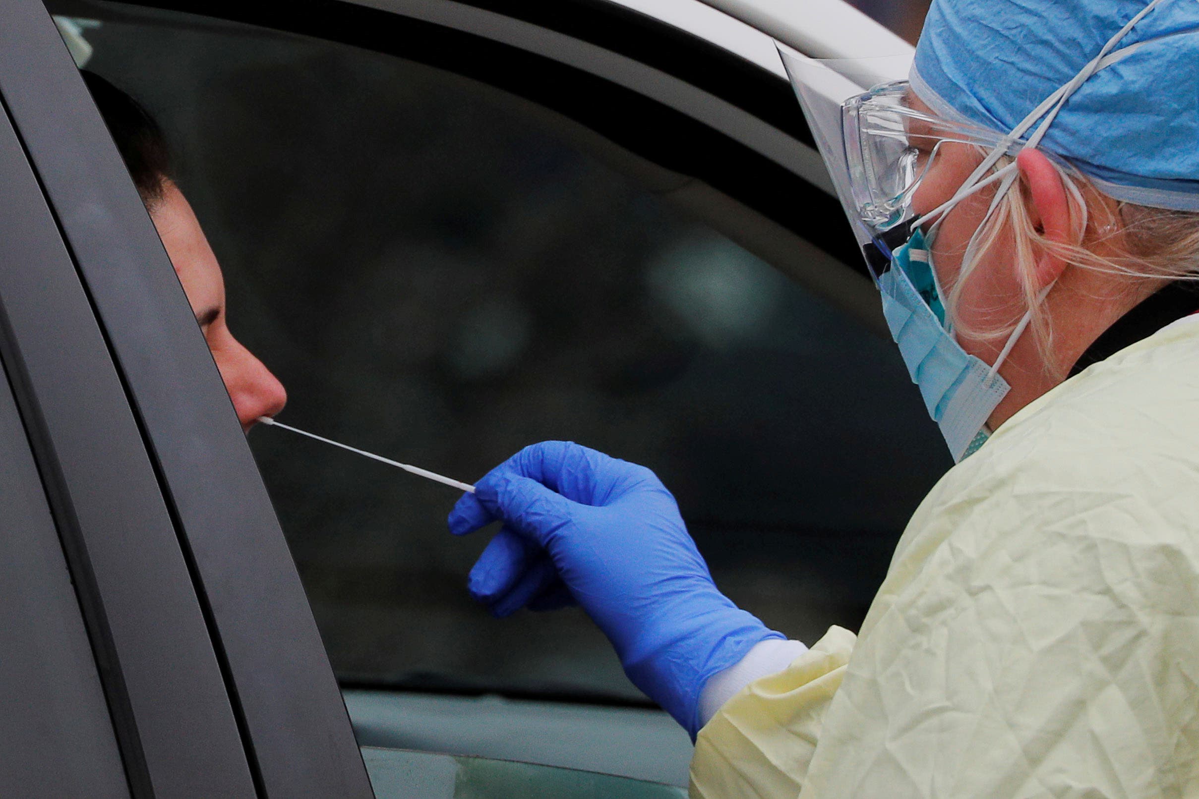 A health care worker receives a sample for analysis in Medford, Massachusetts, USA, on April 4 (from Reuters)