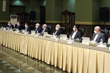 In this photo released by the official website of the Office of the Iranian Presidency, cabinet members wearing face masks attend their meeting in Tehran, Iran on March 18, 2020. (AP)