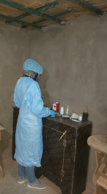 A nurse looks over a small supply of medicine in the camp. (Supplied: Abu Abdullah)