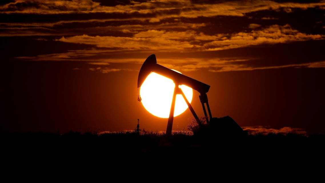 The sun sets behind an idle pump jack near Karnes City, Texas. (AP)