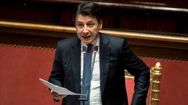 Italian Premier Giuseppe Conte adjusts his jacket as he refers to parliament on the ongoing Covid-19 situation, in Rome on March 26, 2020. (AP)