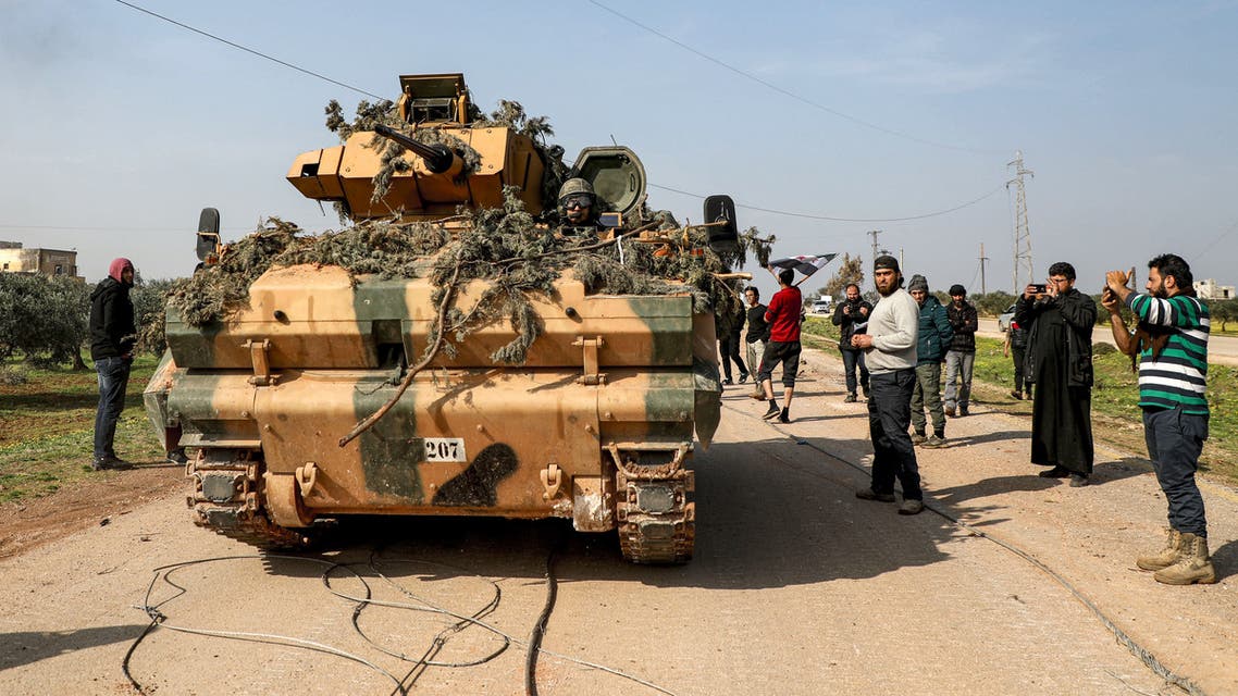 A Turkish military infantry-fighting vehicle (IFV) is seen along the M4 highway, which links the northern Syrian provinces of Aleppo and Latakia, before incoming joint Turkish and Russian military patrols (as per an earlier agreed upon ceasefire deal) in the village of al-Nayrab, about 14 kilometres southeast of the city of Idlib and seven kilometres west of Saraqib in northwestern Syria on March 15, 2020. Russian President Vladimir Putin and his Turkish counterpart Recep Tayyip Erdogan reached a deal on March 5 to create a security corridor with joint Turkish and Russian patrols starting on March 15 along the key M4 highway in northern Syria, which runs roughly parallel to the border with Turkey, from northeastern Kurdish-controlled regions to the Mediterranean coast.