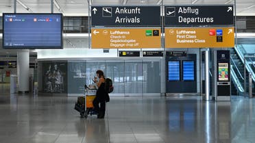 A lone passnager stands in an an empty terminal hall at the Franz-Josef-Strauss airport in Munich, southern Germany, on April 7, 2020 where just a few flights take off and land currently due to the coronavirus COVID-19 pandemic. 