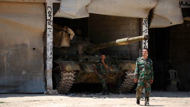 Syrian soldiers stand guard at their military post on the entrance of the central Syrian town of Rastan, Homs province, Syria on July 17, 2018. (AP)