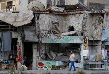 A man walks next to damaged buildings in the old town of Homs, Syria on Aug. 15, 2018. (AP)