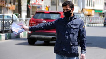 A Iranian man sells face masks on a street in the capital Tehran, during the novel coronavirus pandemic crisis, on April 5, 2020. The spread of the virus in Iran has slowed for the fifth day in a row, according to official figures released today by the authorities, who also announced plans for a gradual resumption of certain economic activities starting on April 11.