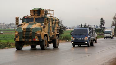 A Turkish military convoy drives on a highway linking Idlib to the Syrian Bab al-Hawa border crossing with Turkey on March 31, 2020. 