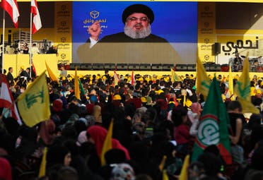 Hezbollah leader Hassan Nasrallah delivers a broadcast speech through a giant screen during an election campaign in a southern suburb of Beirut on April 13, 2018. (AP)