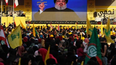 Hezbollah leader Hassan Nasrallah delivers a broadcast speech through a giant screen in a southern suburb of Beirut on April 13, 2018. (File photo: AP)