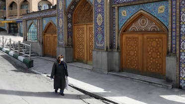 A woman wearing a protective face mask and gloves walks past the Imamzadeh Saleh shrine, amid fear of the coronavirus disease (COVID-19), in Tehran, Iran April 2, 2020. WANA (West Asia News Agency)/Ali Khara via REUTERS ATTENTION EDITORS - THIS PICTURE WAS PROVIDED BY A THIRD PARTY
