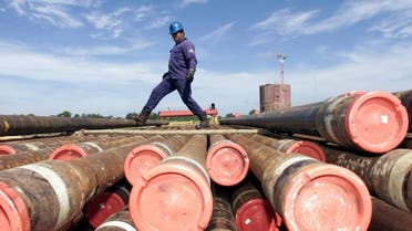 An oil worker with Mexico's state owned oil company, PEMEX (Petroleos de Mexico), kicks a drilling rod as it is hoisted onto an oil platform in the Sen oil field. (File photo: Reuters)