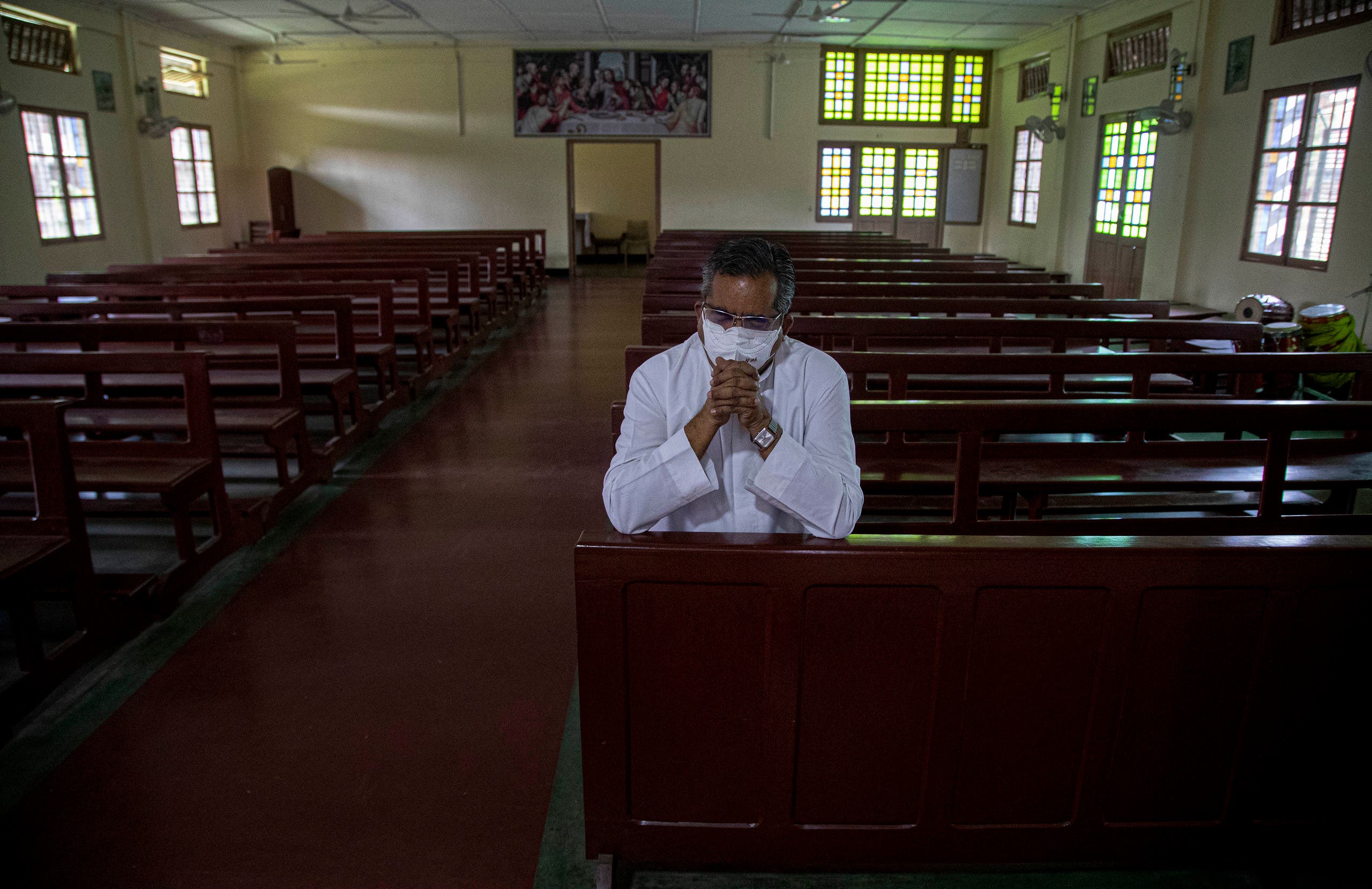 A Catholic priest V.M. Thomas prays in a church on Good Friday in Gauhati, India, Friday, April 10, 2020. (AP)