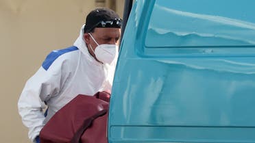 A worker is seen wearing protective clothing at a temporary mortuary in the car park of Central Jamia Mosque Ghamkol Sharif as the spread of the coronavirus disease (COVID-19) continues, Birmingham, Britain, April 10, 2020. REUTERS/Carl Recine