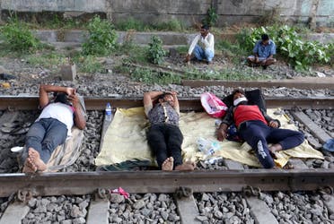 Migrant workers rest on a railway track during a 21-day nationwide lockdown in Mumbai, India. (File photo: Reuters)