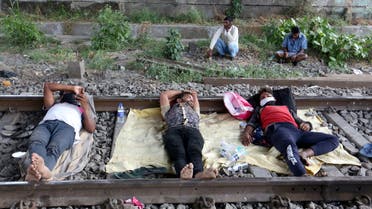 Migrant workers rest on a railway track during a 21-day nationwide lockdown to slow the spreading of coronavirus disease (COVID-19) in in Mumbai, India, April 2, 2020. (Reuters)