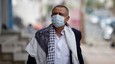 A man wearing a protective face mask walks in the street, amid fear of coronavirus disease (COVID-19), in Sanaa, Yemen. (Reuters)