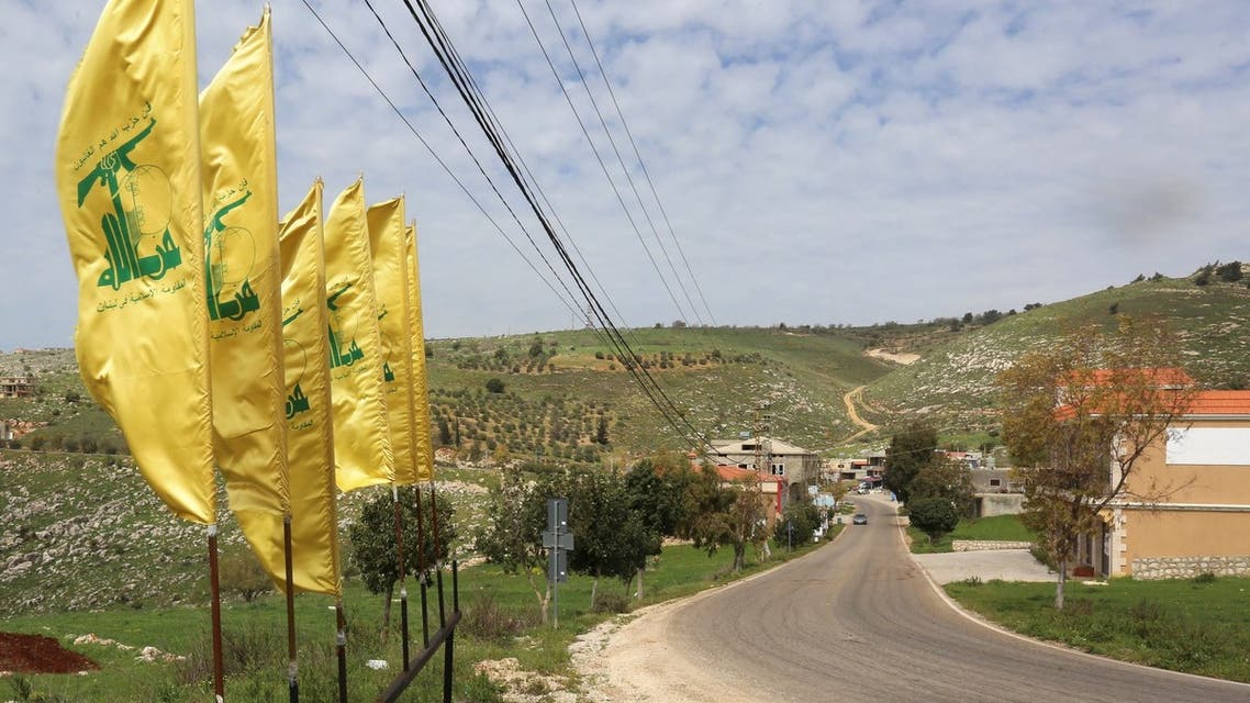 Hezbollah flags flutter along an empty street, at the entrance of Mays Al-Jabal village in Lebanon. (Reuters)