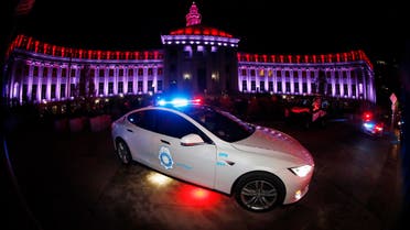 In this April 9, 2020, photo, a Tesla police car sits in front of the City/County Building after red and white lights were illuminated to show support and gratitude for first responders and medical personnel during the outbreak of the new coronavirus in Denver. The coronavirus pandemic that has crippled big-box retailers and mom and pop shops worldwide may be making a dent in illicit business, too. (AP) 