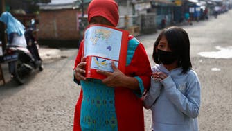 Coronavirus: 'Ghosts' patrol streets in Indonesia to keep people indoors