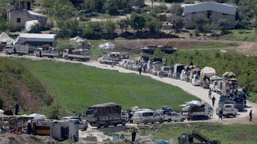 مركبات تحمل متعلقات نازحين عائدين إلى إدلب يوم 11 أبريل (رويترز)