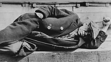 An unemployed man in an old coat is seen lying down on a pier in the New York City docks during the Great Depression. (File photo: Reuters)