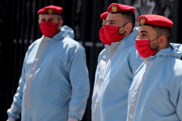 Members of Palestinian Hamas security forces wear protective gear as precaution against the coronavirus at Rafah border crossing in the southern Gaza Strip on April 13, 2020. (Reuters)