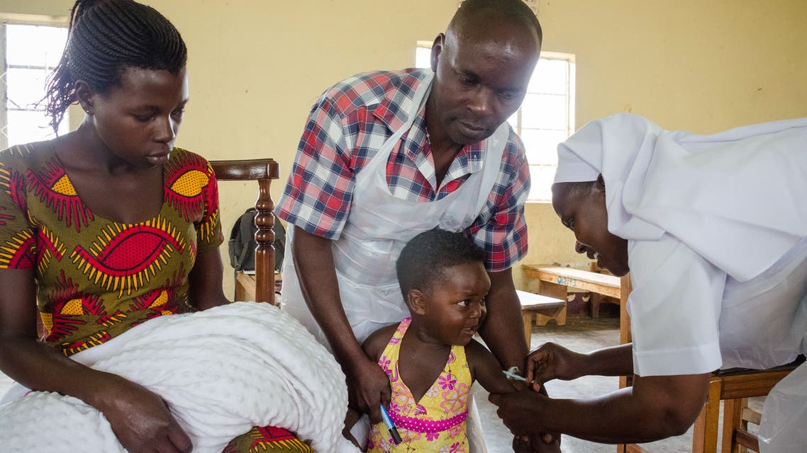A child reacts as he receives an injection during the nationwide vaccination campaign against measles, rubella and polio targeting all children under 15 years old in Nkozi town, about 84 km from the capital Kampala, on October 19, 2019. Uganda's Ministry of health with WHO and UNICEF aim to immunize more than 18 million children in Uganda which is about 43 percent of the population during their 5-day vaccination campaign.