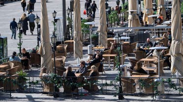 People sit at a cafe terrasse in central Stockholm, Sweden, on April 11, 2020 amid the new coronavirus COVID-19 pandemic. afp
