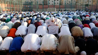 Worshippers attend the Eid al-Fitr prayers in an open field in Amman, Jordan on July 17, 2015. (AP)