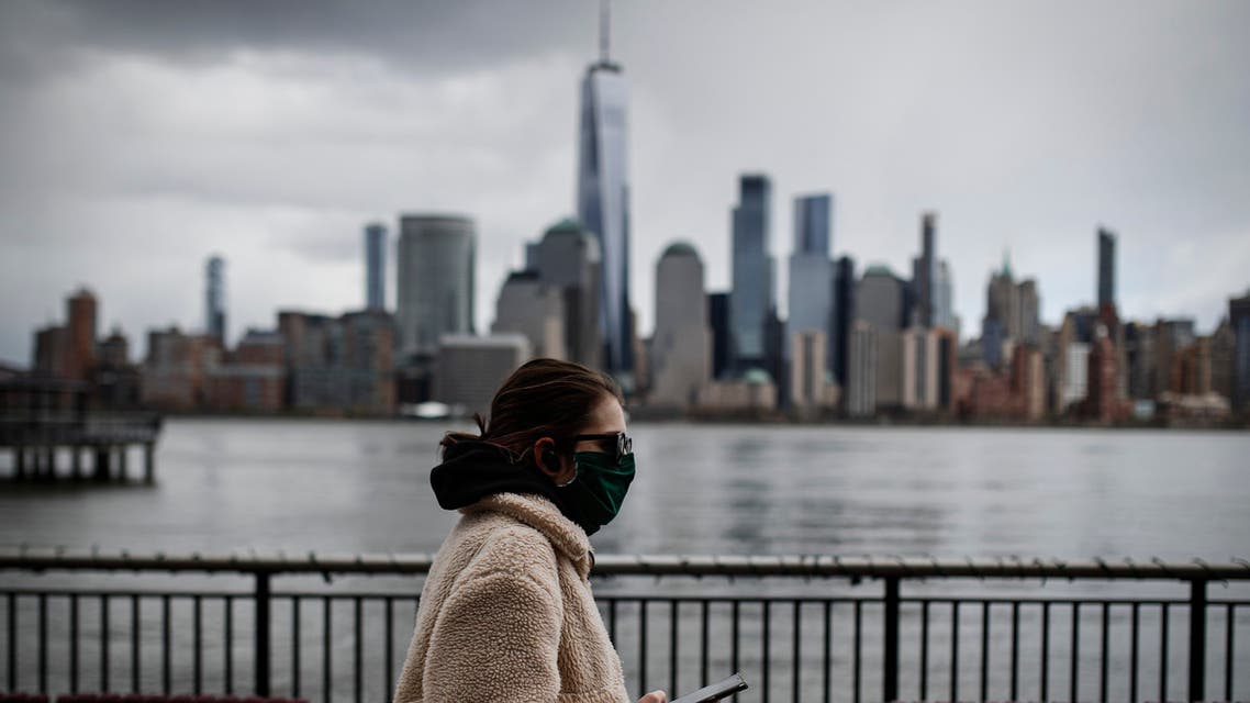  The downtown New York City skyline looms over pedestrians wearing masks due to COVID-19 concerns, Friday, April 10, 2020, in Jersey City, N.J. (AP)