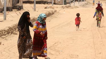 Iraqi displaced women and children, who fled the violence in the northern city of Mosul, walk at the Dibaga camp on July 16, 2016 in Makhmur, about 280 kilometres (175 miles) north of the capital Baghdad. 