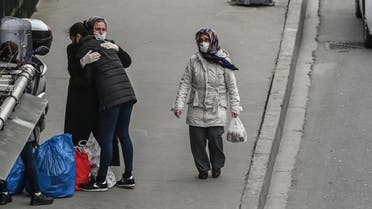 A released woman prisoner hugs her mother after getting off a bus at a bus station near Bakirkoy women prison on April 15, 2020 in Istanbul. (AFP)