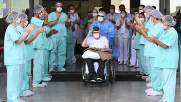 Brazilian 99-year-old former WWII combatant Ermando Armelino Piveta, leaves the Armed Forces Hospital in Brasilia, after being treated for the novel coronavirus COVID-19 and discharged, on April 14, 2020. Piveta was admitted to hospital on April 6 and treated at the hospital's “COVID Ward”, reserved for positive cases of the disease.