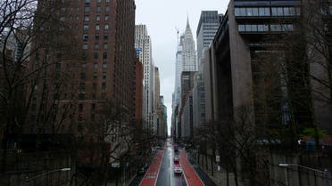 Cars cross 42th street as rain falls on March 28, 2020 in New York City. (AFP)