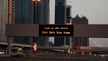 A lone ambulance rushes down the largely empty 12-lane Sheikh Zayed Road in Dubai, United Arab Emirates. (AP)
