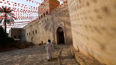  a man walking past the walls of the Nizwa Fort in Oman. (AFP)