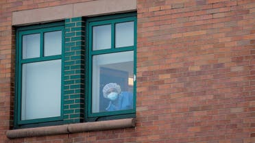 A healthcare worker looks out a window at the emergency center at Maimonides Medical Center during the outbreak of the coronavirus disease (COVID-19) in Brooklyn. (Reuters)